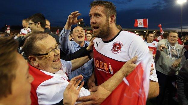 Jon Parkin of Fleetwood Town celebrates at the final whistle with fans during the Sky Bet League Two play off Semi Final second leg match between Fleetwood Town and York