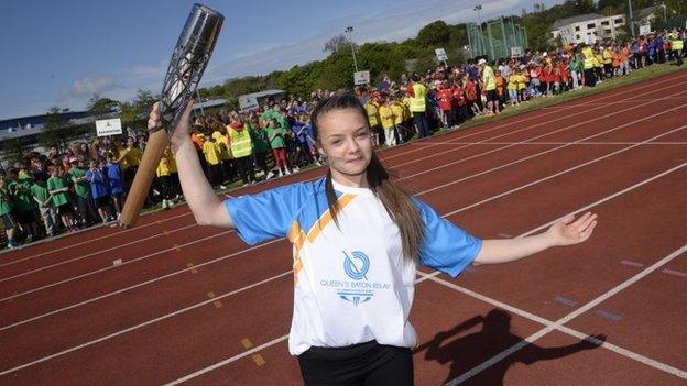 Kaitlin Kneen, 16, holding the Commonwealth Games Baton at The National Sports Centre in Douglas