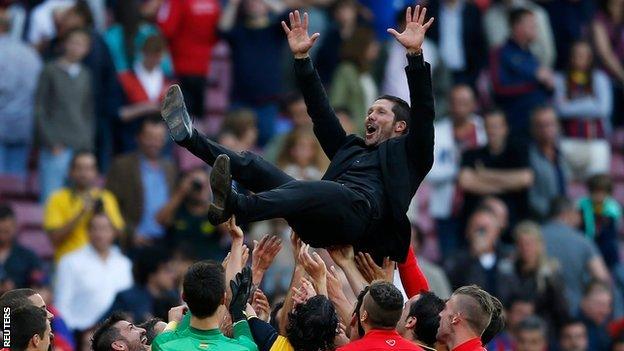 Atletico Madrid's title-winning players celebrate by throwing coach Diego Simeone into the air