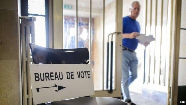 A man arrives to casts his ballot during a referendum on May 18, 2014 in Bulle, western Switzerland