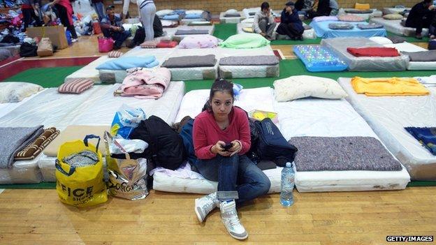 A girl sits on a mattress at a evacuation centre in Belgrade on 17 May 2014