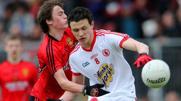 Ronan Miller of Down in action against Tyrone opponent Ronan Nugent