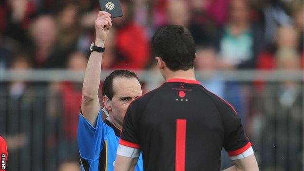 Referee David Coldrick shows a black card to Tyrone keeper Niall Morgan