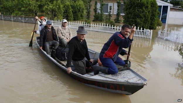 Bosnian people are rescued from their flooded houses by boat in the village of Vidovice near Orasje 200km (124 miles) north of Sarajevo