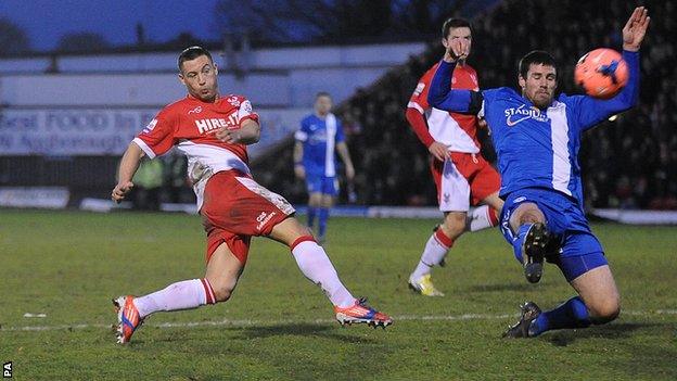 Kidderminster Harriers' Lee Vaughan (left) has a shot on goal against Peterborough United.