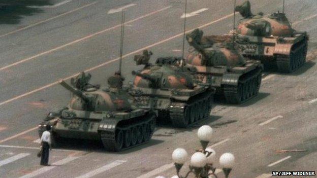 A man stands in front of a tank in Tiananmen Square