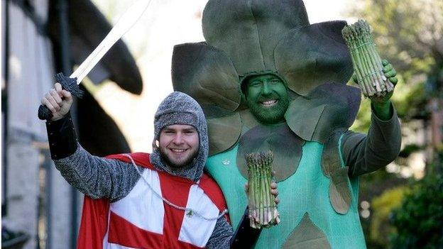 Man dressed as an asparagus and another one dressed as St George