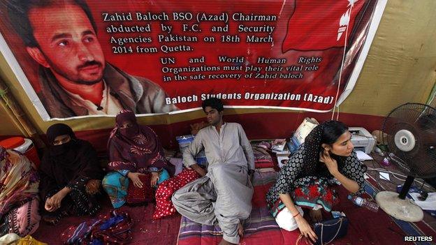 Latif Johar (C), 23, sits in a camp during a hunger strike demanding the release of Zahid Baloch outside Karachi's Press Club on 5 May 2014