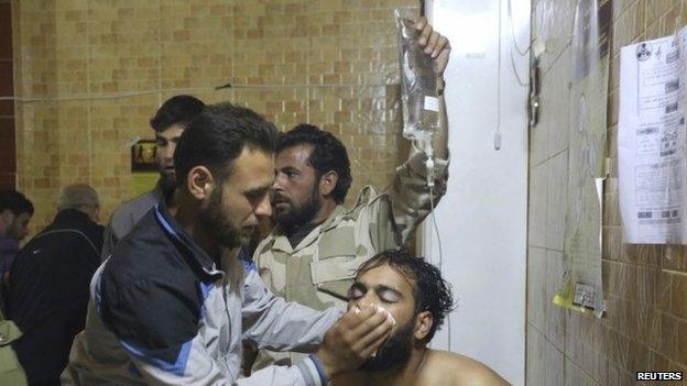 People treat a man affected by what activists say was a gas attack in Kfar Zeita village, inside a hospital in the central province of Hama (19 May 2014)