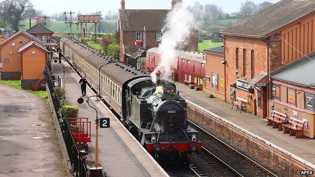 Steam train going through West Somerset Railway line.