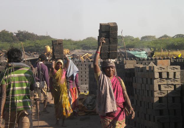 Women carrying bricks