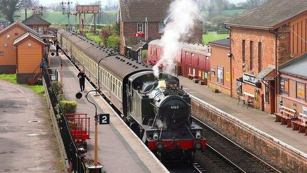 Steam train going through West Somerset Railway line.