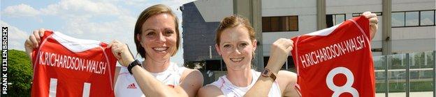 Kate & Helen Richardson-Walsh hold up their shirts with their names on.