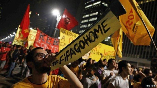 A demonstrator blows a horn during a protest against the 2014 World Cup in Sao Paulo on 15 May, 2014