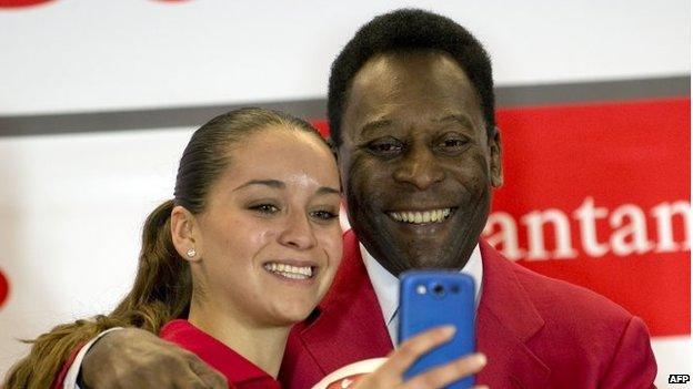 A student takes a selfie with Pele during a press conference in Mexico on 19 May, 2014