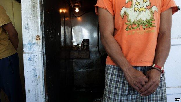 One of the 75 Indonesian fishermen living on seven rusted Taiwanese-registered fishing boats stands at Cape Town Harbour on 28 November, 2013