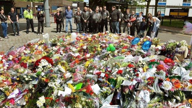 Floral tributes outside the main gate of the Royal Artillery Barracks in Woolwich, south-east London, near to the spot where Lee Rigby was hacked to death,