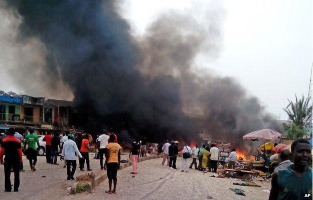 Smoke rises after a bomb blast at a bus terminal in Jos, Nigeria, on 20 May 2014