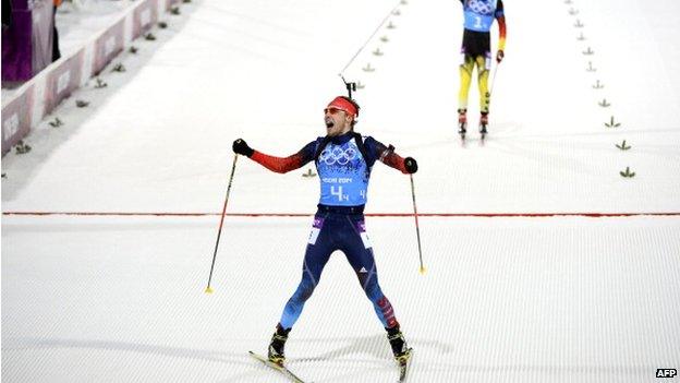 File photo: Russia's Anton Shipulin (bottom) crosses the finish line ahead of Germany's Simon Schempp in the Men's Biathlon 4x7.5 km Relay at the Laura Cross-Country Ski and Biathlon Center during the Sochi Winter Olympics on in Rosa Khutor, near Sochi, 22 February 2014