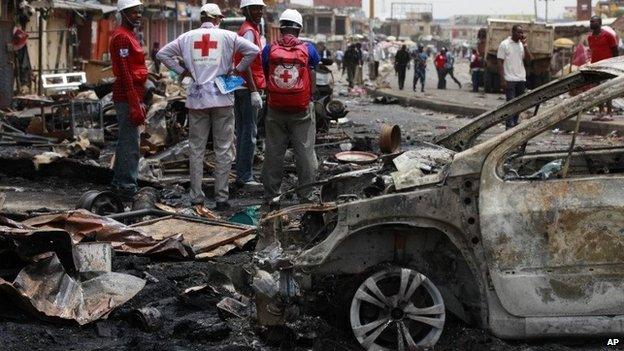 Red Cross personnel search for remains at the site of one of Tuesday's car bomb in Jos, May 21