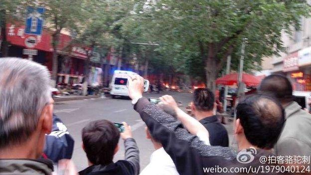 Onlookers in Urumqi after blast in the market (22 May)