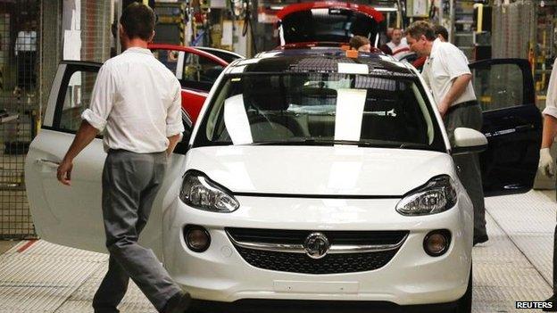 Employees work at the production line on an Opel Adam car in Germany