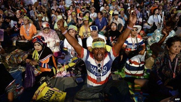 Thai anti-government protesters celebrate at their camp outside Government House after Thailand"s army chief announced that the armed forces were seizing power, in Bangkok on May 22, 2014.