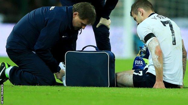 Jack Wilshere is given treatment during the International Friendly match between England and Denmark.