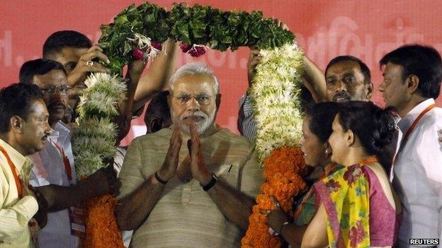 Narendra Modi being garlanded by supporters at a public meeting in the western city of Ahmedabad May 20, 2014.