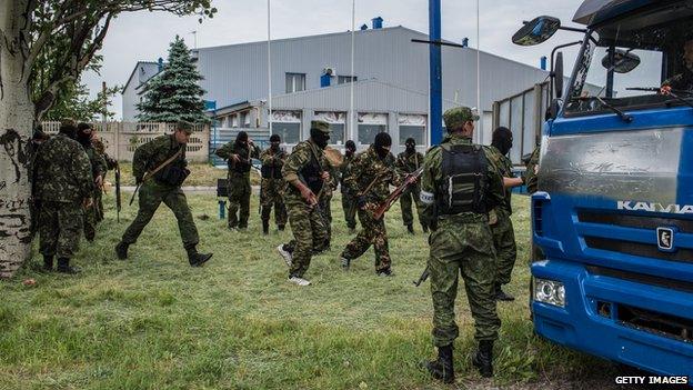 Members of the pro-Russia Vostok Battalion assemble along the side of the road following early morning clashes with pro-Ukraine fighters on 23 May 2014 in Pisky, Ukraine.