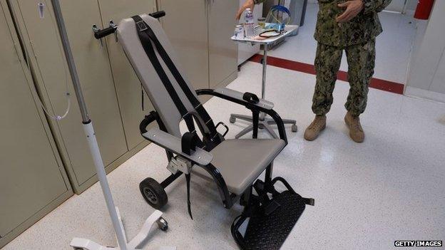 This photo reviewed by the US military and made during an escorted visit shows a US naval medic explaining the "feeding chair" procedures at the detention facility in Guantanamo Bay, Cuba 9 April 2014