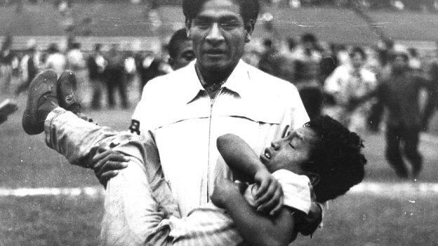 Man carrying injured boy