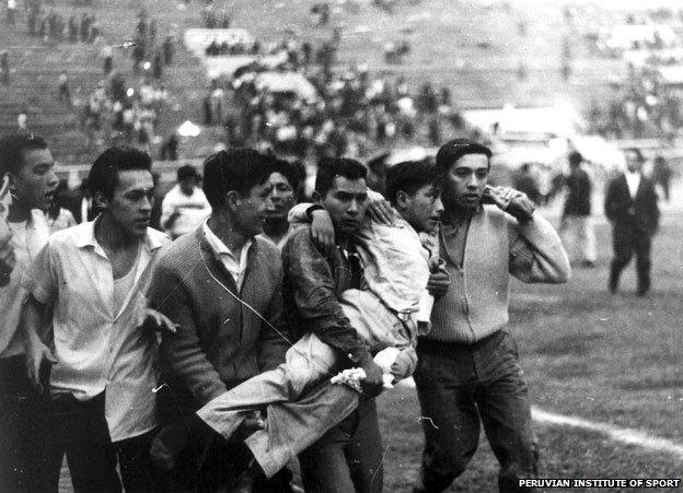 Youths carrying boy