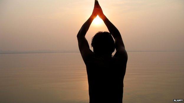 Man at prayer by the banks of the River Ganges