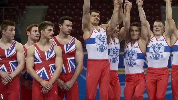 British male gymnasts (l) with winners Russia (r)