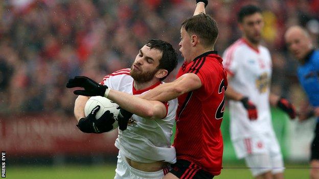 Ronan McNamee is challenged by Jerome Johnston at Pairc Esler