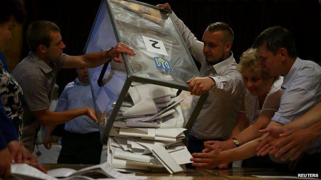 Members of the election commission empty ballot boxes in a polling station in the town of Rohatyn in western Ukraine on 25 May 2014.