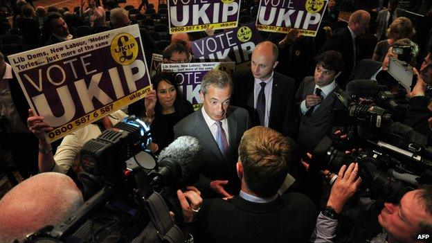 Nigel Farage surrounded by supporters and media