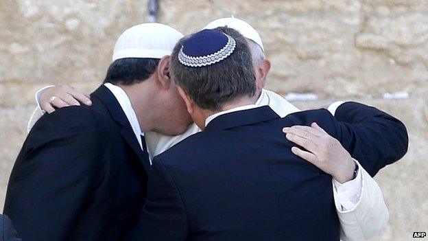 Pope Francis embraces two close friends from Argentina - an imam, Omar Abboud, and a rabbi, Abraham Skorka - at the Western Wall in Jerusalem's Old City (26 May 2014)