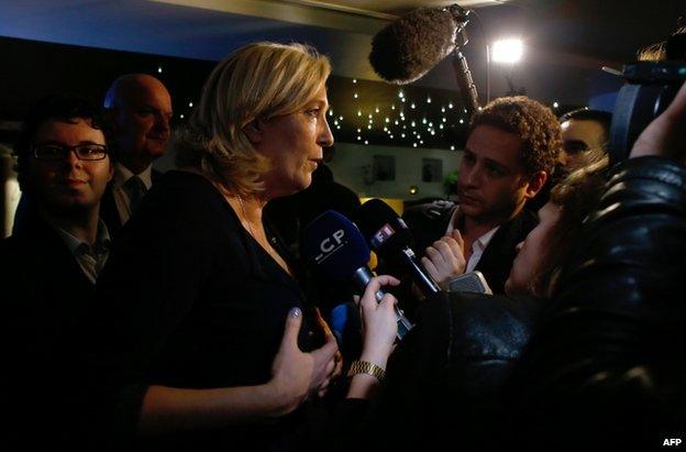 Marine Le Pen answers questions from journalists during a party at the Elysee Lounge bar, in Paris, 25 May