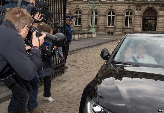 Prime Minister Elio Di Rupo waves as he leaves the Royal Palace in Brussels