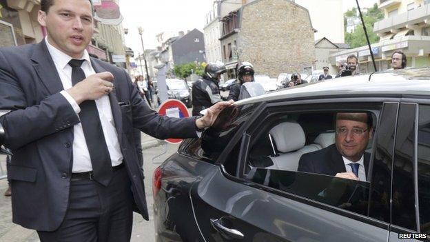 France's President Francois Hollande sits in his car