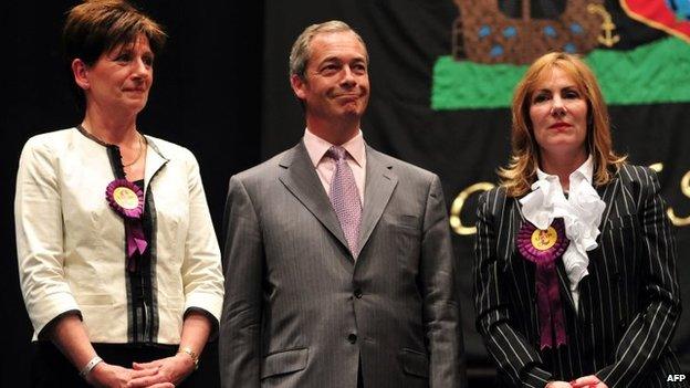 UK Independence Party (UKIP) leader Nigel Farage (C) stands on stage after being re-elected as an MEP flanked by fellow UKIP MEPs Janice Atkinson (R) and Diane James (L) (25 May 2016)