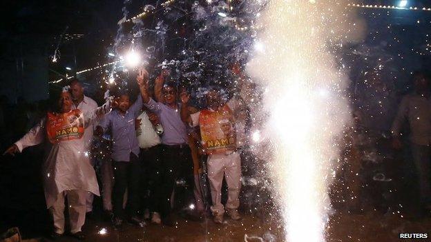 BJP supporters light fireworks to celebrate Narendra Modi's swearing in outside the BJP headquarters in Delhi May 26, 2014