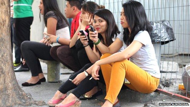 Group of Filipinos using mobile phones