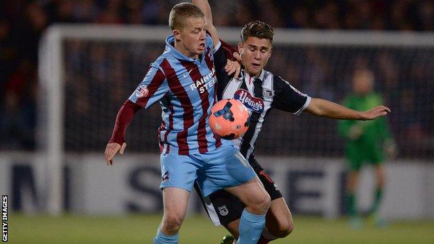 Terry Hawkridge (l) of Scunthorpe United challenges Scott Neilson of Grimsby Town