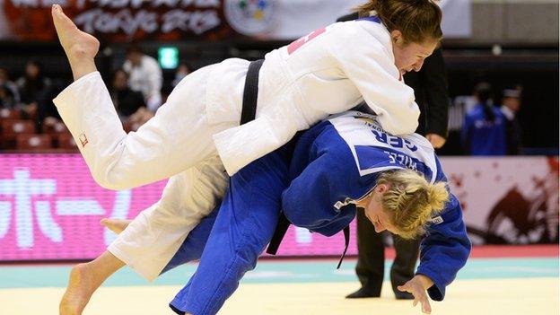 Natalie Powell (white) of Great Britain and Kerstin Thiele of Germany compete clash at the the 2013 Judo Grand Slam in Tokyo