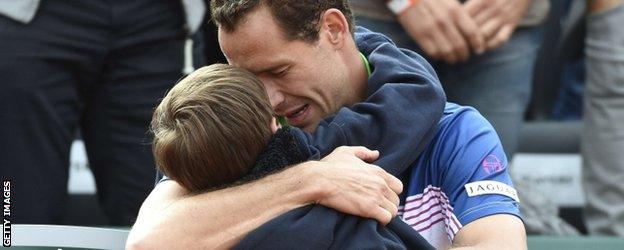 Michael Llodra embraces his son after his last professional match