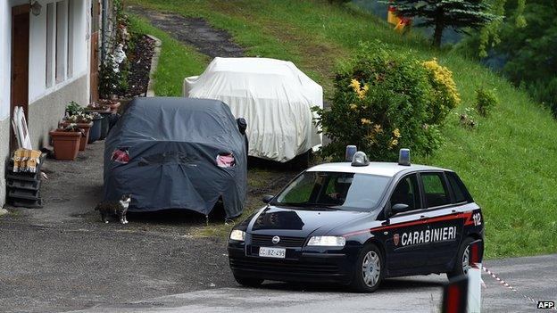 An Italian Police car drives onto a road that was closed following an accident near Germany"s national football team"s training camp in San Martino in Passiria on May 27