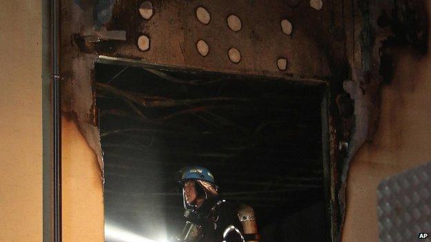 Firefighters search a hospital after a fire swept through the building in Jangseong, South Korea, Wednesday, 28 May.